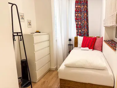 a small bedroom with a bed and a dresser at Lukerly 2 in Belgrade
