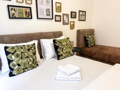 a bedroom with a bed and a couch at Lukerly 2 in Belgrade
