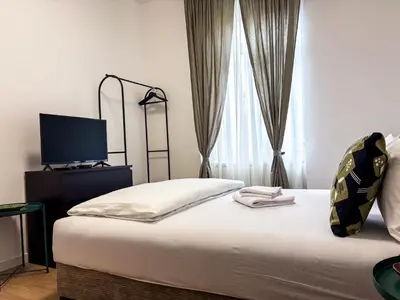 a bedroom with a bed with a flat screen tv at Lukerly 2 in Belgrade