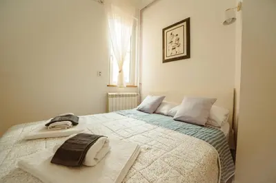 a bedroom with a bed with two towels on it at Mizi Apartment in Belgrade