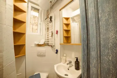 a small bathroom with a sink and a toilet at Mizi Apartment in Belgrade
