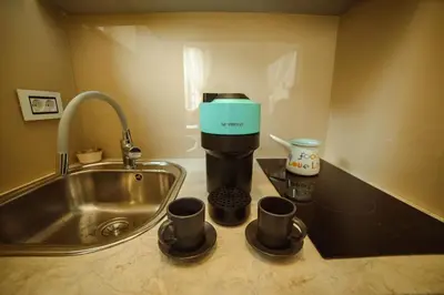 a coffee maker on a counter next to a sink at Mizi Apartment in Belgrade