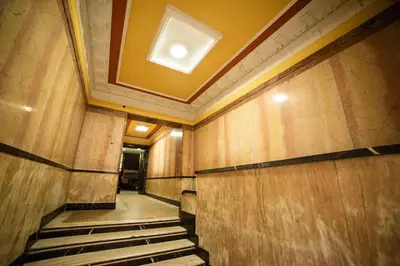 a hallway of a building with a light on the ceiling at Mizi Apartment in Belgrade