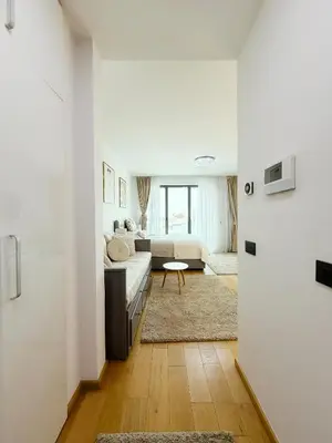 a white living room with a couch and a table at SARA Lux Novi Dorcol in Belgrade