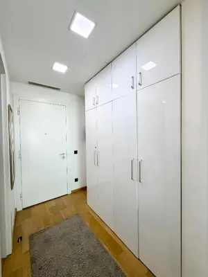 a room with white cabinets and a rug at SARA Lux Novi Dorcol in Belgrade