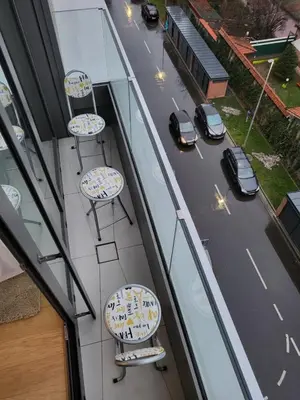 a balcony with chairs and a road with cars at SARA Lux Novi Dorcol in Belgrade