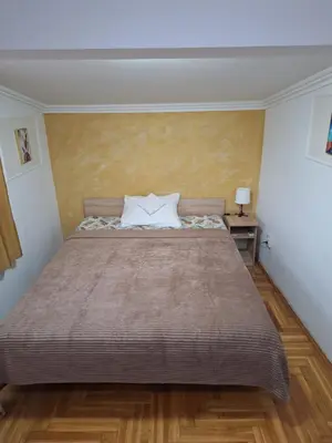 a bedroom with a large bed in a room at Rooms3 in Beograd