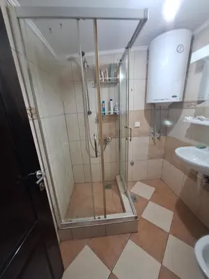a shower with a glass door in a bathroom at Rooms3 in Beograd
