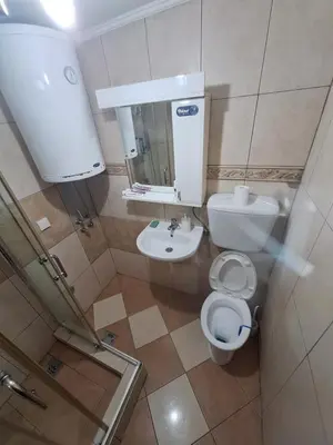 a small bathroom with a toilet and a sink at Rooms3 in Beograd