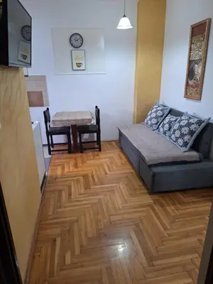 a living room with a couch and a table at Rooms3 in Beograd