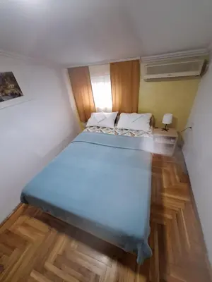 a bedroom with a large bed in a room at Rooms3 in Beograd