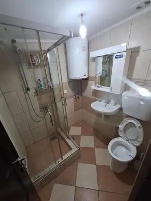 a bathroom with a shower and a toilet and a sink at Rooms3 in Beograd