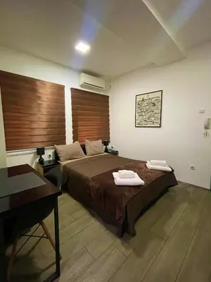 a bedroom with a bed with two towels on it at Skadarlija Nest in Belgrade