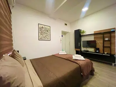 a bedroom with a bed with two towels on it at Skadarlija Nest in Belgrade