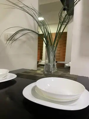a black table with white plates and a vase at Skadarlija Nest in Belgrade