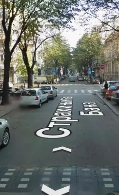 a street with cars parked on the road at Center Belgrade in Belgrade