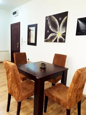 a dining room table with chairs and a picture on the wall at Center Belgrade in Belgrade