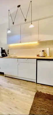 a kitchen with white cabinets and a counter top at Center Belgrade in Belgrade