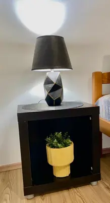 a table with a lamp and a plant on it at Center Belgrade in Belgrade