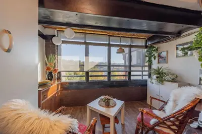 a living room with a table and chairs and a window at Ada Home Belgrade Apartment