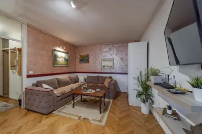 a living room with a couch and a table at Ada Home Belgrade Apartment