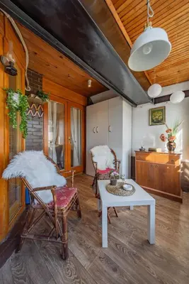 a living room with rocking chairs and a table at Ada Home Belgrade Apartment