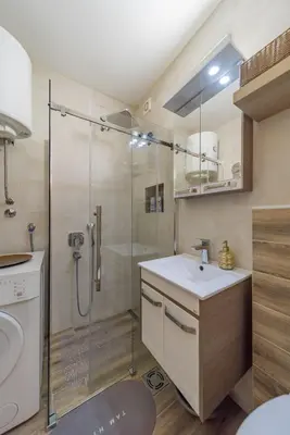 a bathroom with a sink and a shower at Ada Home Belgrade Apartment