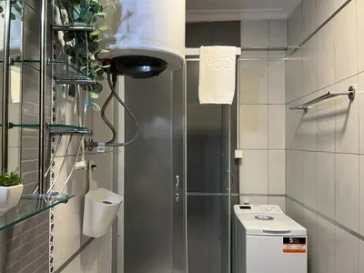 a small bathroom with a shower and a toilet at Liberte Apartments 2 Voždovac in Belgrade