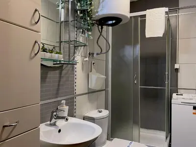 a bathroom with a sink and a toilet and a shower at Liberte Apartments 2 Voždovac in Belgrade