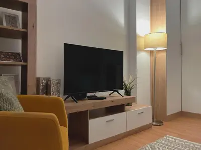 a living room with a flat screen tv on a table at Liberte Apartments 2 Voždovac in Belgrade