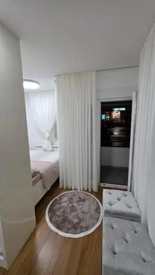 a bedroom with a bed and a couch and a table at Apartman Beograd in Belgrade