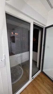 a sliding glass door with a view of a balcony at Apartman Beograd in Belgrade
