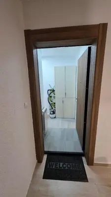 a door leading into a room with a refrigerator at Apartman Beograd in Belgrade