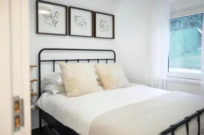 a bedroom with a bed with four pictures on the wall at Villa Vista Slankamen in Stari Slankamen