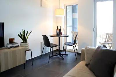 a living room with a table with chairs and a couch at Villa Vista Slankamen in Stari Slankamen