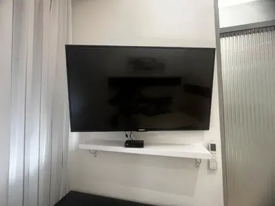 a flat screen tv hanging on a wall at WhiteCity Suite in Belgrade