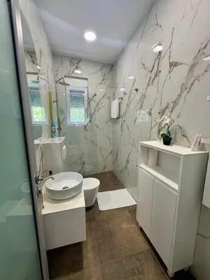 a bathroom with a toilet and a sink at WhiteCity Suite in Belgrade