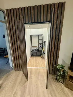 a hallway with a mirror and a room with a desk at WhiteCity Suite in Belgrade