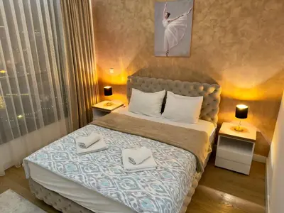 a bedroom with a bed with two towels on it at Belgrade Waterfront River & City View Apartment in Belgrade