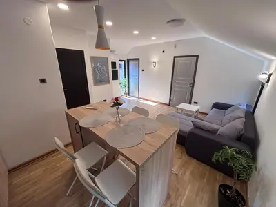 a living room with a table and a couch at Pejton Apartment in Belgrade