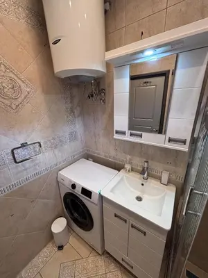 a bathroom with a washing machine and a sink at Pejton Apartment in Belgrade