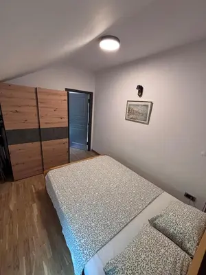 a bedroom with two twin beds and a closet at Pejton Apartment in Belgrade