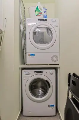 a washer and a washing machine in a room at The Sensation Belgrade Waterfront in Belgrade
