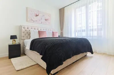 a bedroom with a large bed and a window at The Sensation Belgrade Waterfront in Belgrade