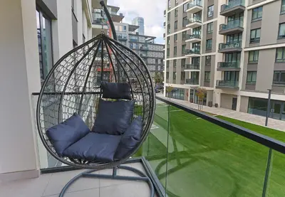 a swing chair sitting on top of a balcony at The Sensation Belgrade Waterfront in Belgrade