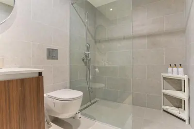 a bathroom with a shower with a toilet and a sink at The Sensation Belgrade Waterfront in Belgrade