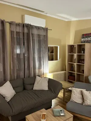 a living room with a couch and a table at Crown Apartment in Belgrade