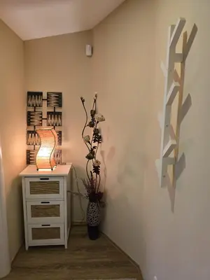 a room with a desk with a lamp and flowers at Crown Apartment in Belgrade