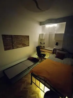 a bedroom with a bed and a desk and a chair at Vuk i Vojvoda in Belgrade