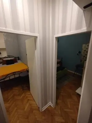 a hallway with a room with a bed in it at Vuk i Vojvoda in Belgrade
